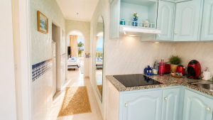 Bright kitchen in the Panorama Studio with a view through the hallway to the living and sleeping area